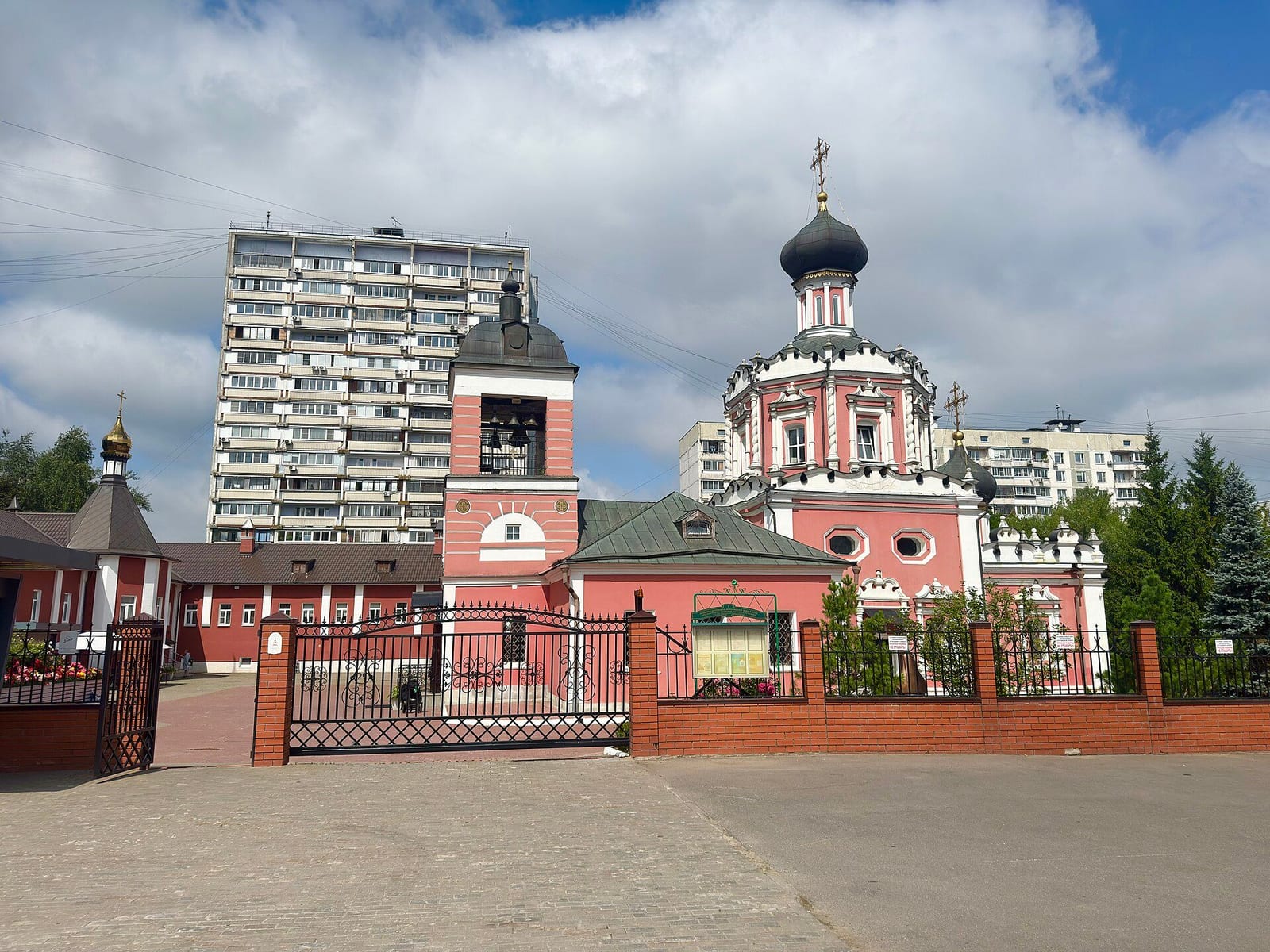 Храм в Коньково среди домов 1970-х годов. Усадьба Коньково-Сергиевская и церковь внесены в реестр как памятники федерального значения. июль 2026